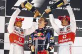 Чемпионы двух последних сезонов Льюис Хэмильтон и Дженсон Баттон поздравляют новоиспеченного короля "Формулы-1" Себастьяна Феттеля